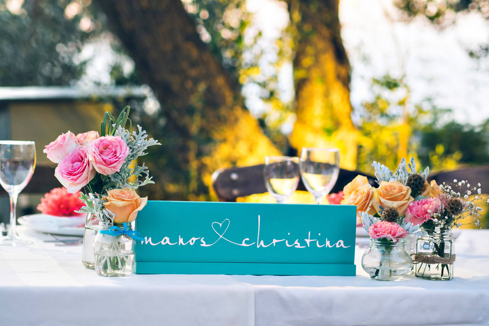 The happy couple's table, decorated with colourful fresh flowers.