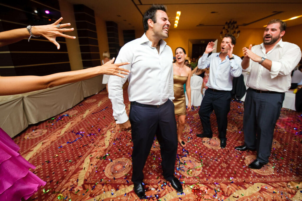 Energetic wedding guest showcasing dance moves during the lively celebration.