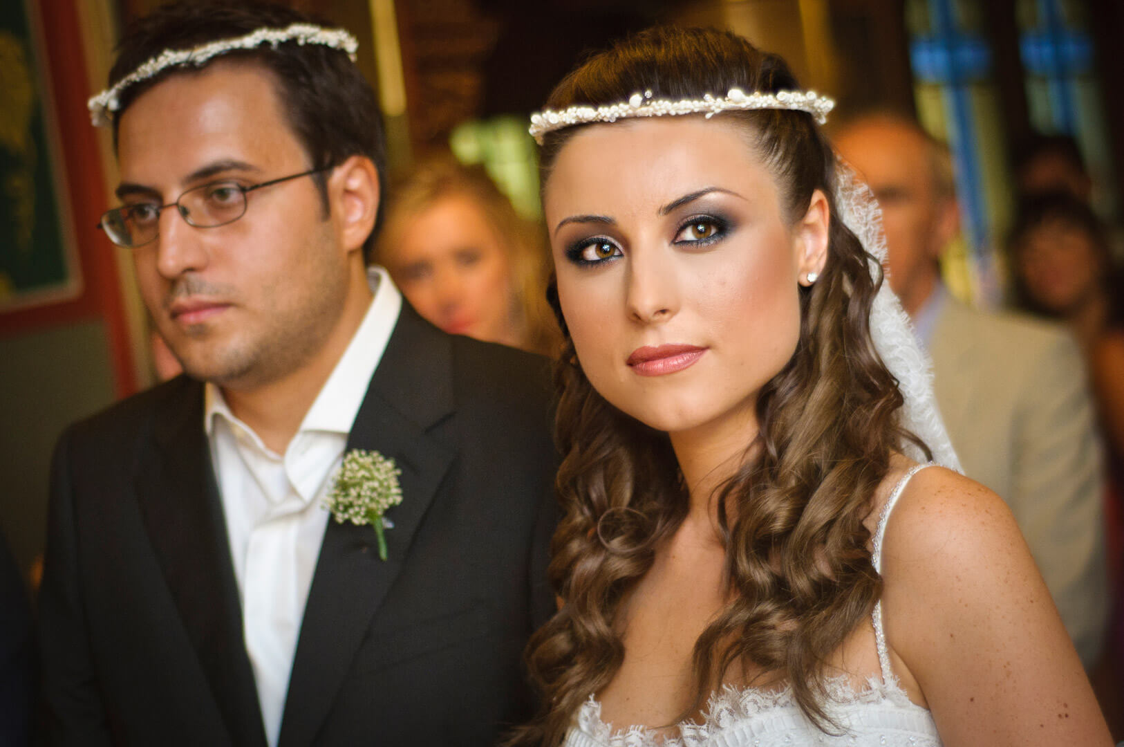 The couple adorned with wedding crowns, the bride wearing a dreamy expression, creating a magical and enchanting scene