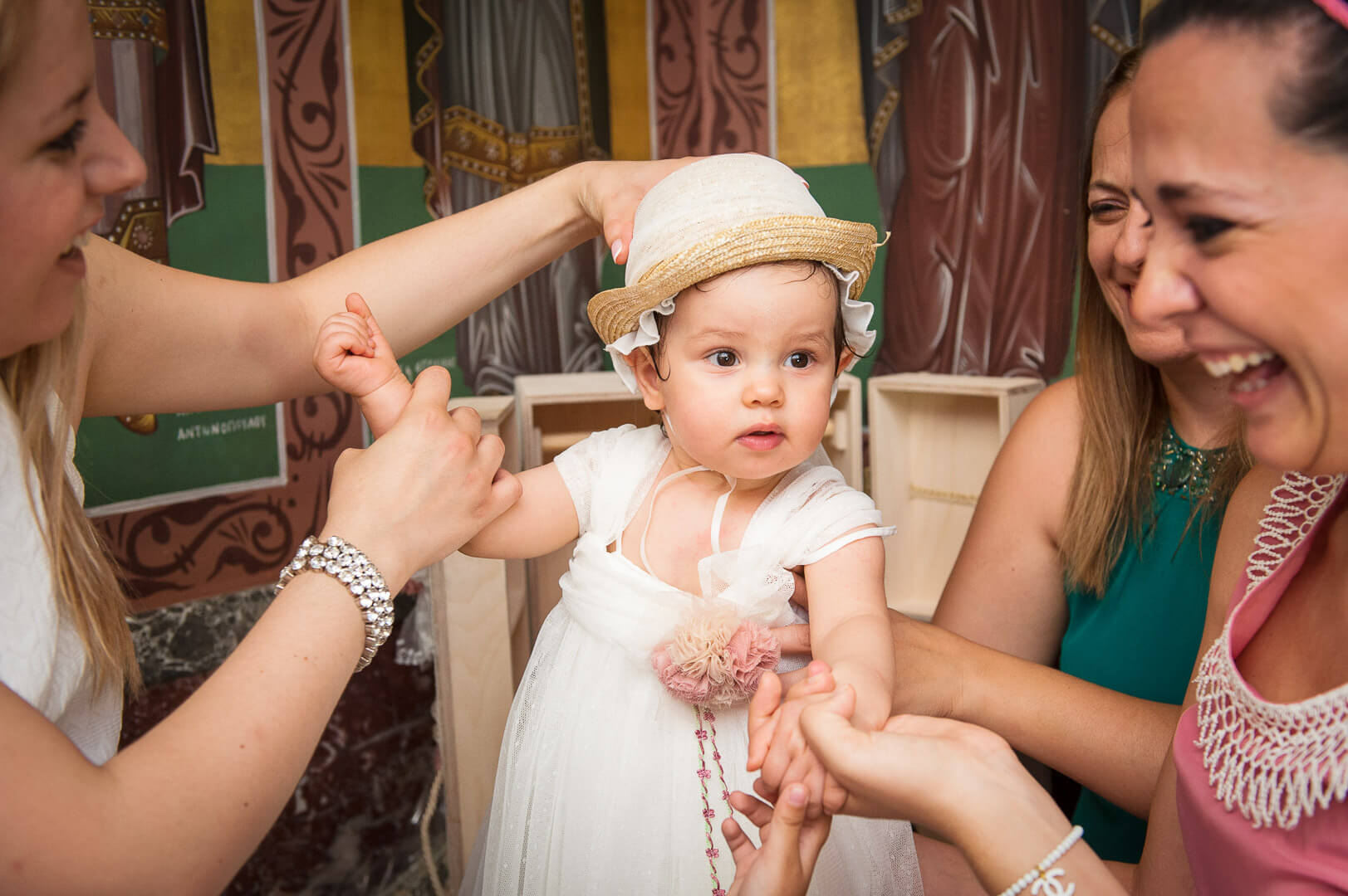 Christening joy continues: gentle touches as baby gets dressed for new adventures.