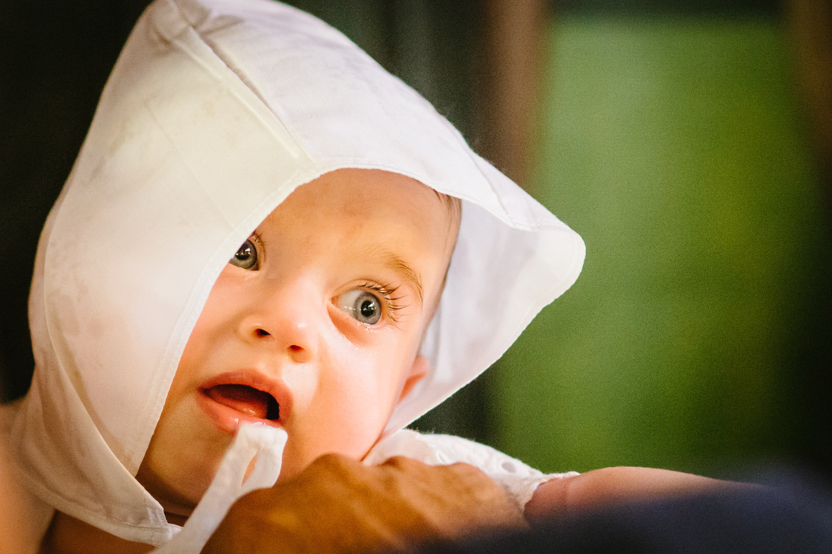Precious innocence: close-up portrait of a baptized baby, angelic in white.