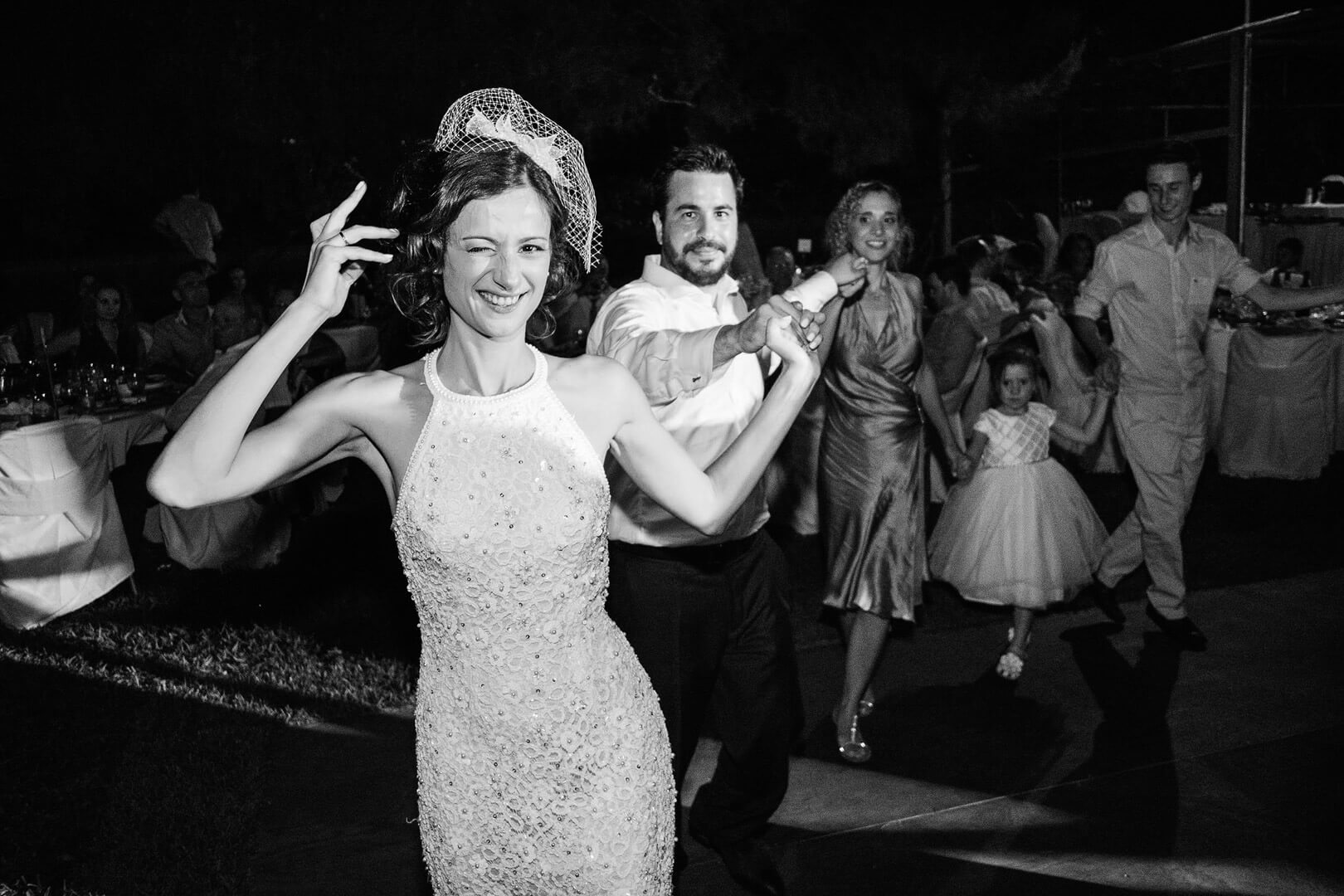 The bride leading the dance winking at the camera